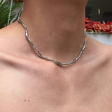 White gold necklace with intertwined wave pattern