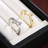 Crossed white gold ring with zirconias