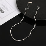 White gold necklace with intertwined wave pattern