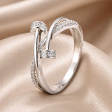 Crossed white gold ring with zirconias