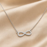 White gold necklace with infinity pendant and zirconia.