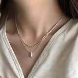 Double-layer white gold necklace with drop-shaped pendant